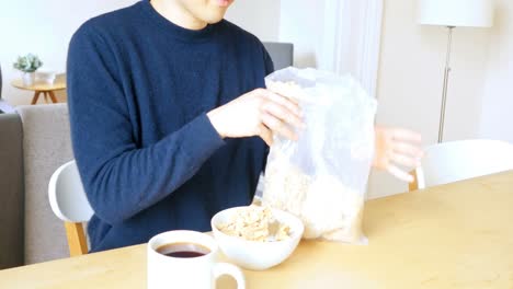 Man-pouring-breakfast-cereal-into-bowl-4k