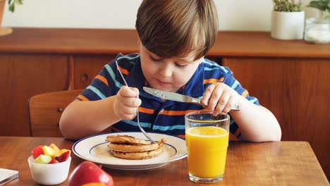 Boy-having-breakfast-on-dinning-table-4k