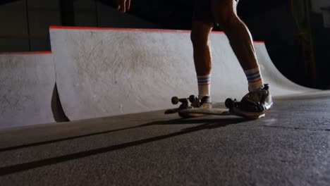 Man-practicing-skateboarding-in-skateboard-arena-4k