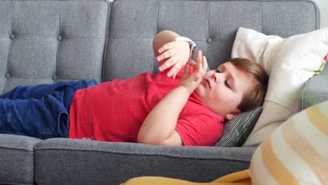 Boy-using-smartwatch-in-living-room-4k