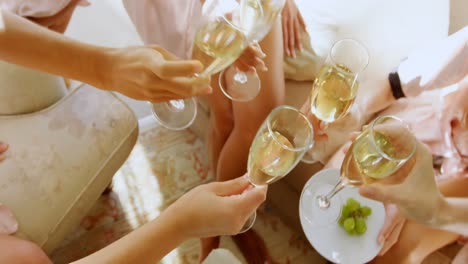 Bridesmaids-in-nightdress-toasting-a-glass-of-champagne-4K-4k