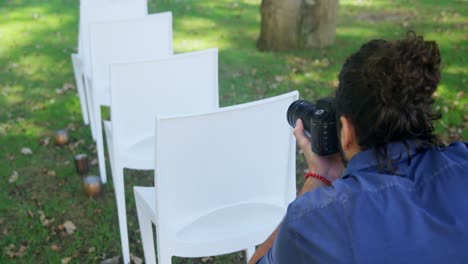 Photographer-taking-photo-of-chairs-4K-4k
