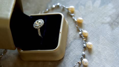 Diamond-wedding-ring-and-pearl-necklace-4k