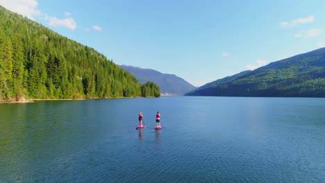 Couple-rowing-a-stand-up-paddle-board-in-the-river-4k