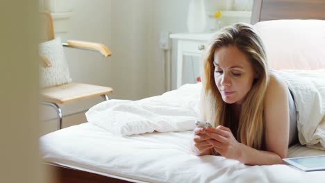 Woman-using-mobile-phone-on-bed-4k-