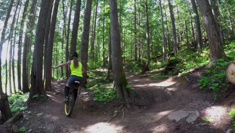 Woman-riding-unicycle-in-the-forest-4k