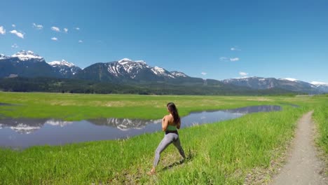 Woman-practicing-yoga-in-the-grassland-