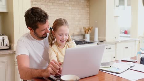 Smiling-father-sitting-on-chair-assisting-his-daughter-with-laptop-4K-4k