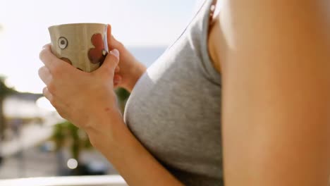 Young-woman-having-coffee-on-a-sunny-day-4k