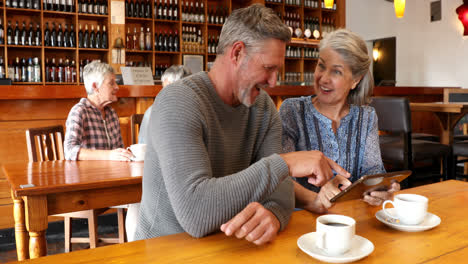 Senior-couple-using-digital-tablet-in-restaurant-4k