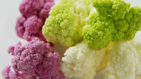 Bunch-of-colorful-cauliflowers-on-white-background-4K-4k