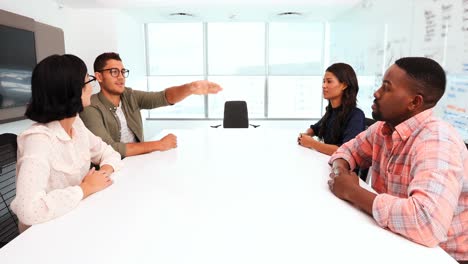 Business-colleagues-using-invisible-screen-in-conference-room-4k