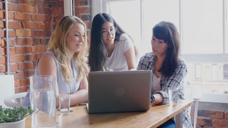 Businesswomen-discussing-over-laptop-in-office-4k