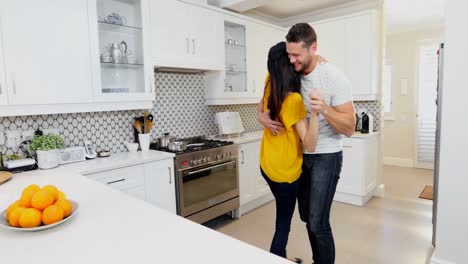 Couple-dancing-kitchen-at-home-4k