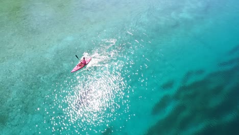 Aerial-view-of-woman-kayaking-on-a-lake-4k