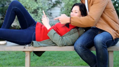 Couple-using-mobile-phone-while-interacting-with-each-other-4k
