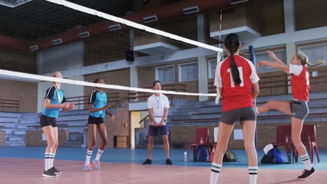 Female-players-playing-volleyball-in-the-court-4k