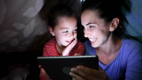 Mother-and-daughter-using-digital-tablet-at-home-4k