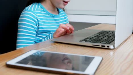 Girl-using-laptop-at-home-4k