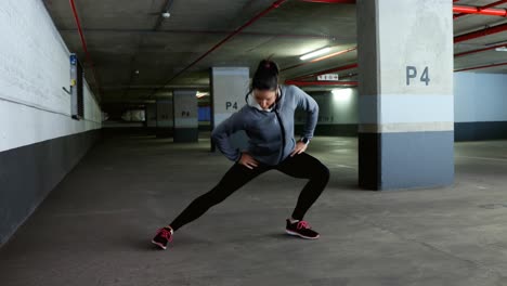 Woman-exercising-at-underground-car-parking-lot-4k