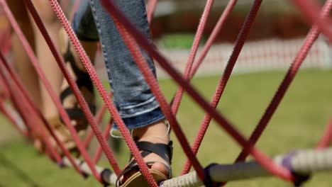 Kids-walking-on-a-rope-bridge-in-the-garden-4k