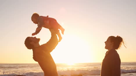 Father-and-mother-playing-with-their-baby-boy-in-the-beach-4k
