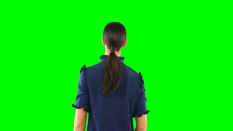 Woman-looking-at-invisible-screen-against-green-screen-4k