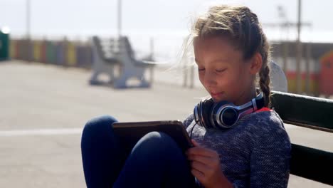 Girl-using-digital-tablet-at-beach-4k