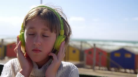 Girl-listening-music-on-headphones-at-beach-4k