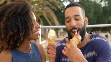 Couple-eating-ice-cream-cone-at-beach-4k