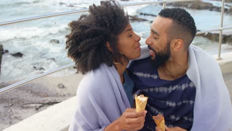 Couple-having-ice-cream-cone-at-beach-4k