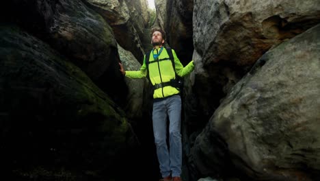 Male-hiker-exploring-a-cave-4k
