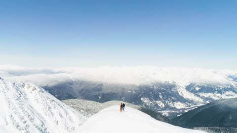 Skiers-standing-on-a-snow-capped-mountain-4k