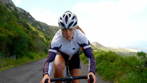 Female-cyclist-cycling-on-a-countryside-road-4k-