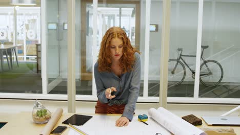Female-architect-working-at-desk-4k