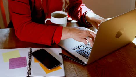 Mature-woman-using-laptop-at-home-4k