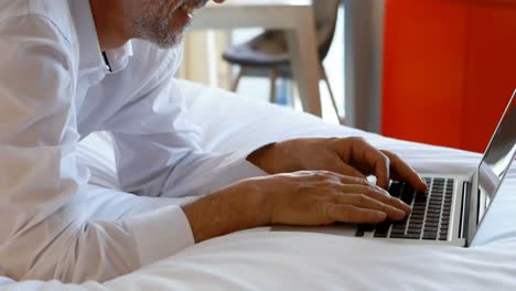 Businessman-using-laptop-in-hotel-room-4k