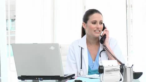 Attractive-female-doctor-on-phone-