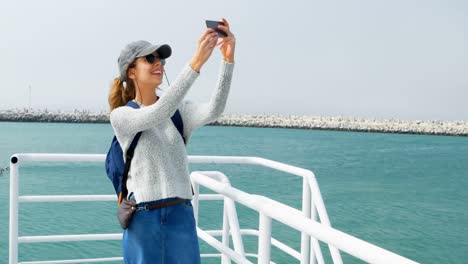 Woman-taking-selfie-with-mobile-phone-while-travelling-in-ferry-4k
