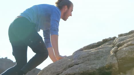 Male-hiker-raising-hands-on-the-top-of-mountain-4k
