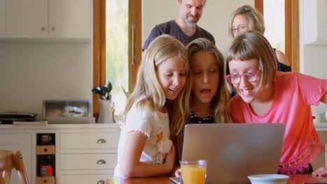 Kids-using-laptop-in-kitchen-4k