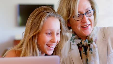 Mother-and-daughter-interacting-with-each-other-while-using-laptop-4k