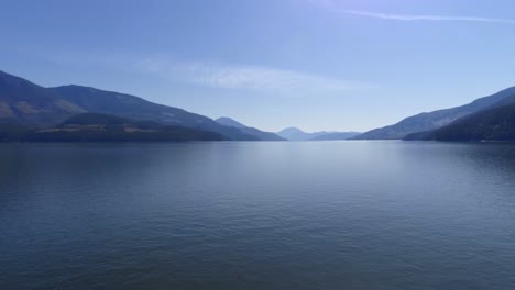 Beautiful-lake-surrounded-by-rocky-mountain-range-4k