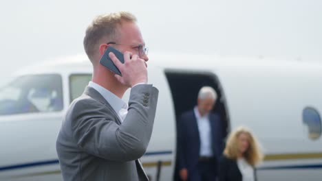 Businessman-talking-on-mobile-phone-at-terminal-4k