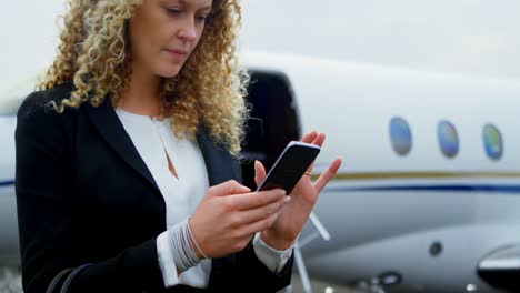 Businesswoman-using-mobile-phone-at-terminal-4k