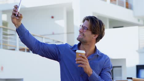 Man-taking-selfie-with-mobile-phone-in-the-balcony-4k