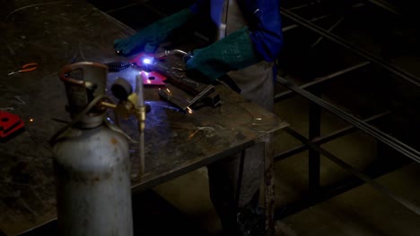 Female-welder-using-blowing-torch-on-a-rod-4k