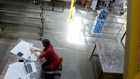 Female-welder-working-at-desk-4k