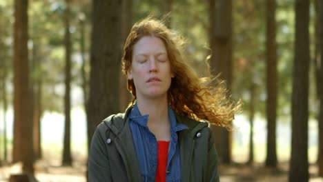 Woman-standing-with-eyes-closed-in-the-forest-4k