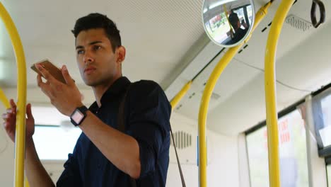 Male-commuter-talking-on-mobile-phone-while-travelling-in-bus-4k